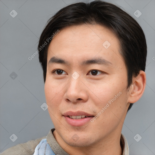 Joyful asian young-adult male with short  brown hair and brown eyes