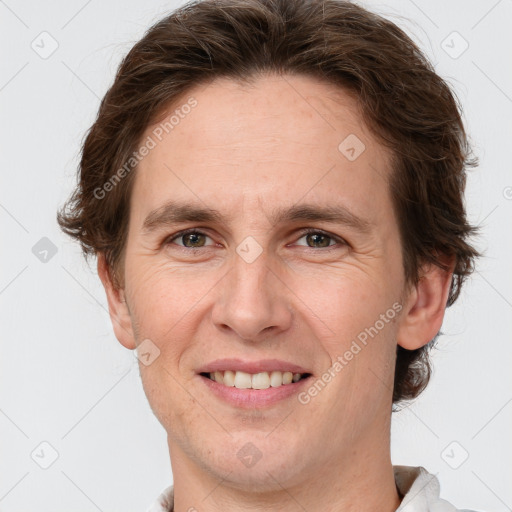 Joyful white adult male with short  brown hair and grey eyes