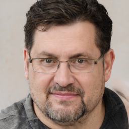 Joyful white adult male with short  brown hair and grey eyes