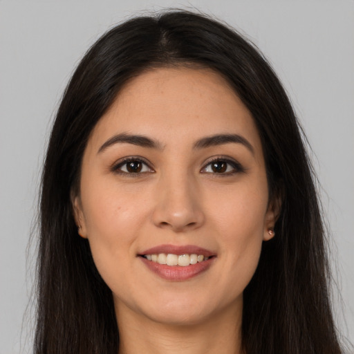 Joyful white young-adult female with long  brown hair and brown eyes