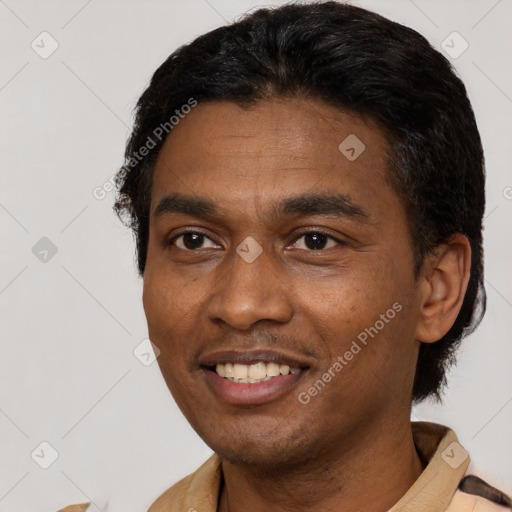 Joyful latino young-adult male with short  black hair and brown eyes