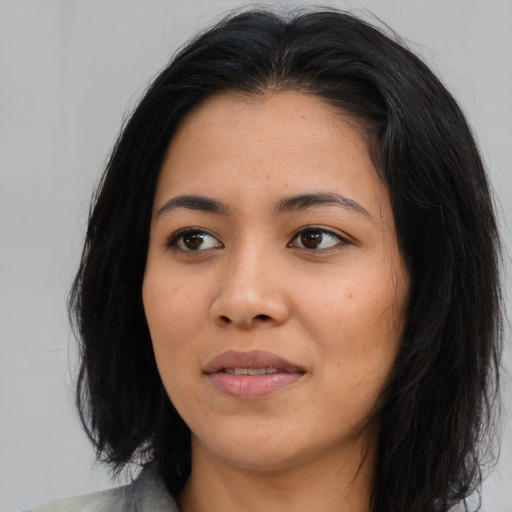 Joyful asian young-adult female with medium  black hair and brown eyes