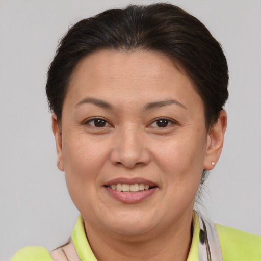 Joyful white adult female with short  brown hair and brown eyes