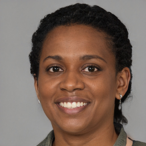 Joyful black young-adult female with medium  brown hair and brown eyes