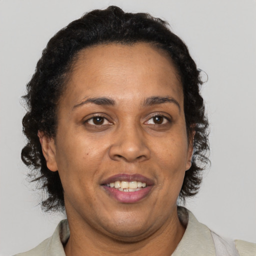 Joyful black adult female with short  brown hair and brown eyes