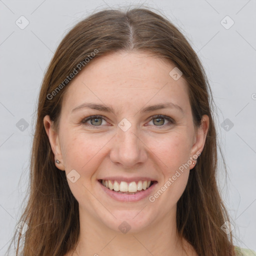 Joyful white young-adult female with long  brown hair and grey eyes