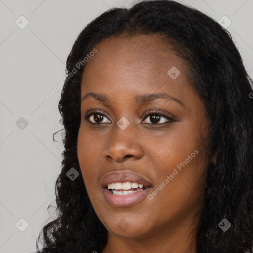 Joyful black young-adult female with long  black hair and brown eyes