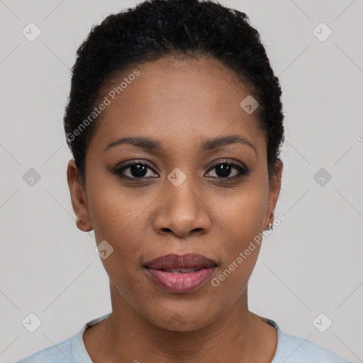 Joyful black young-adult female with short  black hair and brown eyes