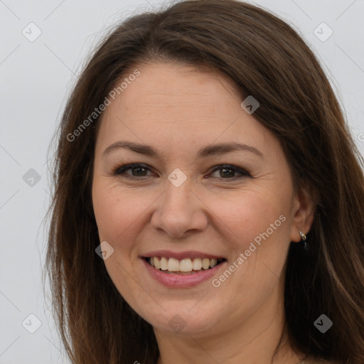 Joyful white adult female with long  brown hair and brown eyes