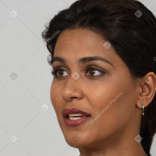 Joyful black young-adult female with medium  brown hair and brown eyes