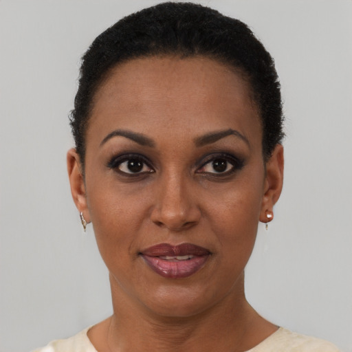 Joyful black young-adult female with short  brown hair and brown eyes