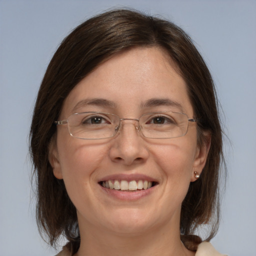 Joyful white adult female with medium  brown hair and grey eyes