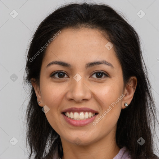 Joyful latino young-adult female with long  brown hair and brown eyes