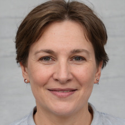 Joyful white adult female with short  brown hair and grey eyes