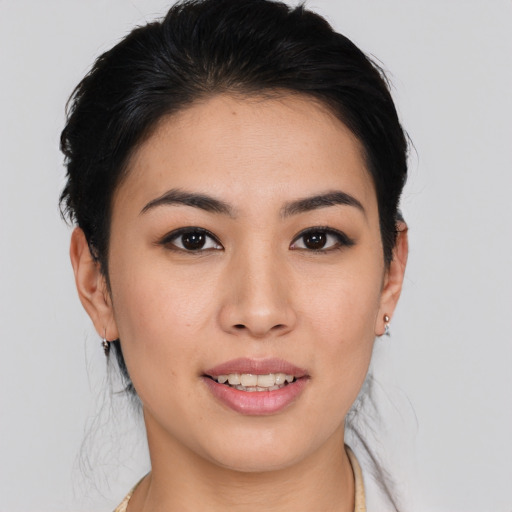 Joyful asian young-adult female with medium  brown hair and brown eyes