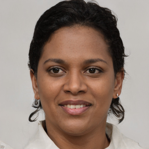 Joyful black young-adult female with short  brown hair and brown eyes