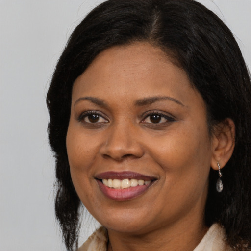 Joyful latino adult female with long  brown hair and brown eyes