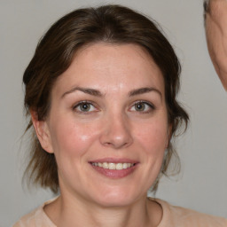 Joyful white young-adult female with medium  brown hair and brown eyes