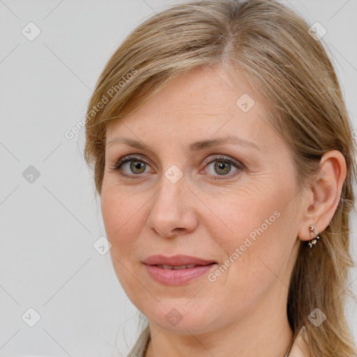 Joyful white adult female with long  brown hair and brown eyes