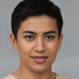 Joyful latino young-adult male with short  brown hair and brown eyes