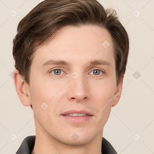 Joyful white young-adult male with short  brown hair and grey eyes