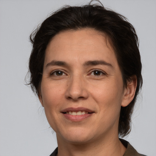 Joyful white adult female with medium  brown hair and brown eyes