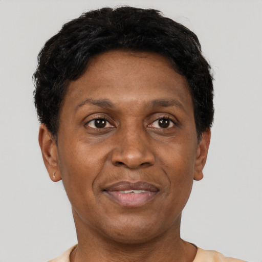 Joyful black adult male with short  black hair and brown eyes
