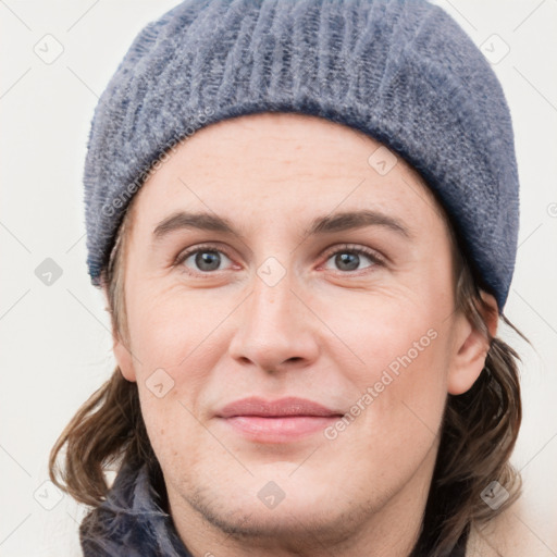 Joyful white young-adult female with medium  brown hair and blue eyes