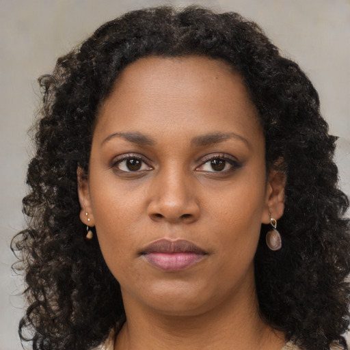 Neutral black young-adult female with long  brown hair and brown eyes
