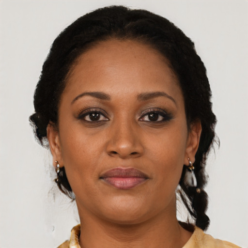 Joyful black adult female with medium  brown hair and brown eyes