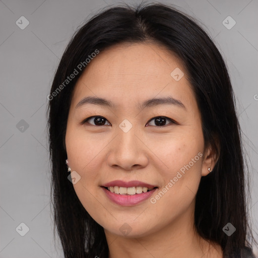 Joyful asian young-adult female with long  brown hair and brown eyes