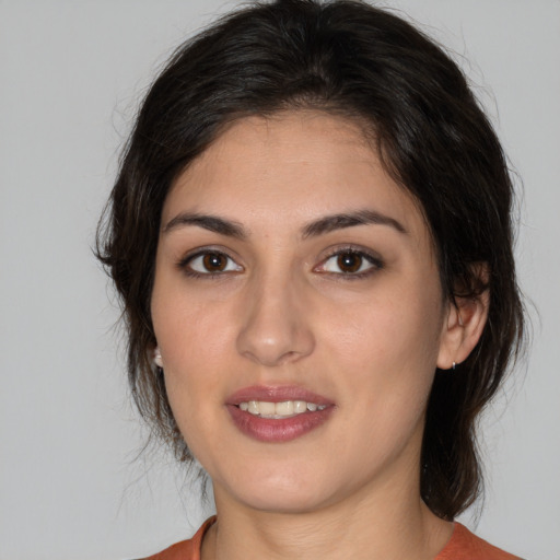 Joyful white young-adult female with medium  brown hair and brown eyes