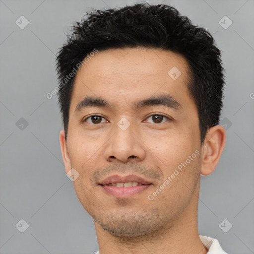 Joyful asian young-adult male with short  black hair and brown eyes