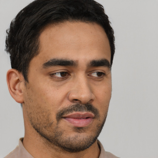 Neutral latino young-adult male with short  black hair and brown eyes