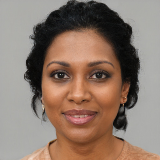 Joyful black young-adult female with medium  brown hair and brown eyes