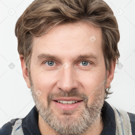 Joyful white adult male with short  brown hair and grey eyes