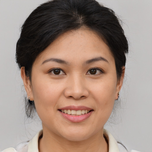 Joyful asian young-adult female with medium  brown hair and brown eyes