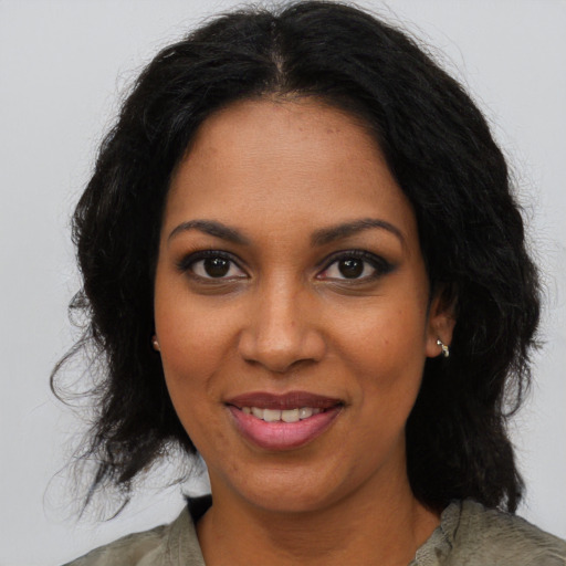 Joyful black young-adult female with medium  brown hair and brown eyes