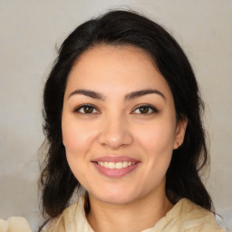 Joyful latino young-adult female with medium  brown hair and brown eyes