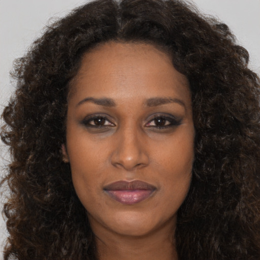 Neutral black adult female with long  brown hair and brown eyes