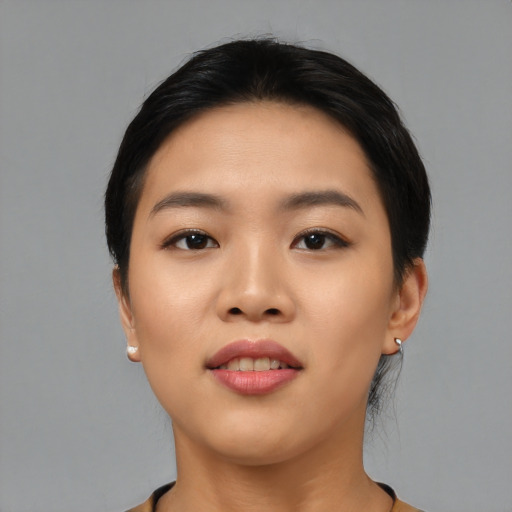 Joyful asian young-adult female with medium  black hair and brown eyes