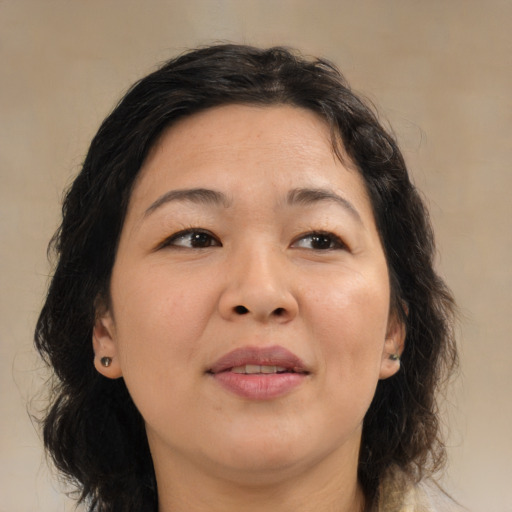 Joyful asian adult female with medium  brown hair and brown eyes