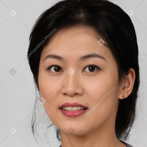 Joyful asian young-adult female with medium  black hair and brown eyes