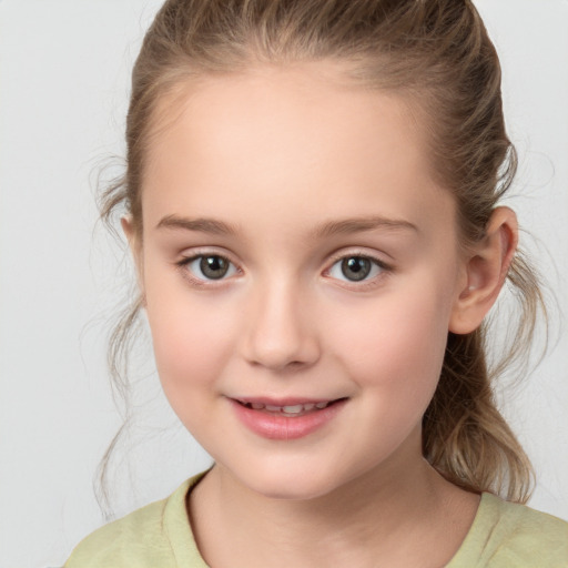 Joyful white child female with medium  brown hair and brown eyes