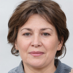 Joyful white adult female with medium  brown hair and grey eyes