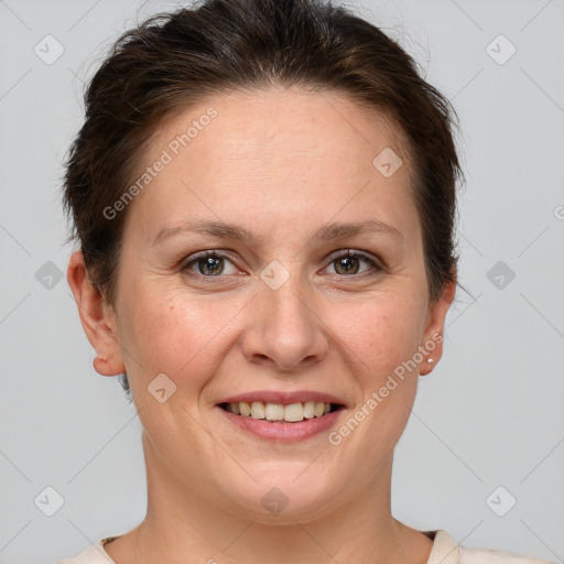 Joyful white adult female with short  brown hair and grey eyes