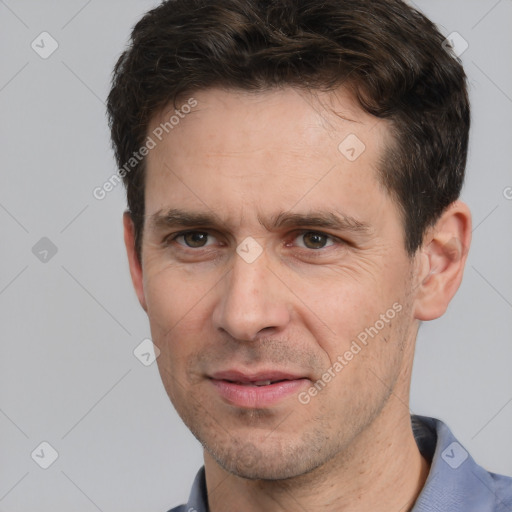 Joyful white adult male with short  brown hair and brown eyes