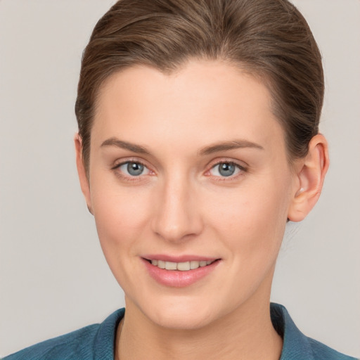 Joyful white young-adult female with short  brown hair and grey eyes