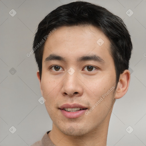 Joyful asian young-adult male with short  brown hair and brown eyes