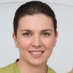 Joyful white young-adult female with short  brown hair and grey eyes